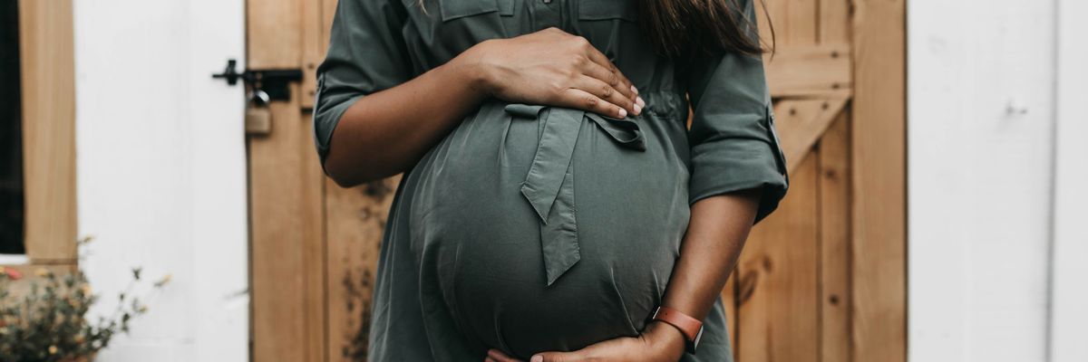 A pregnant woman in a green dress