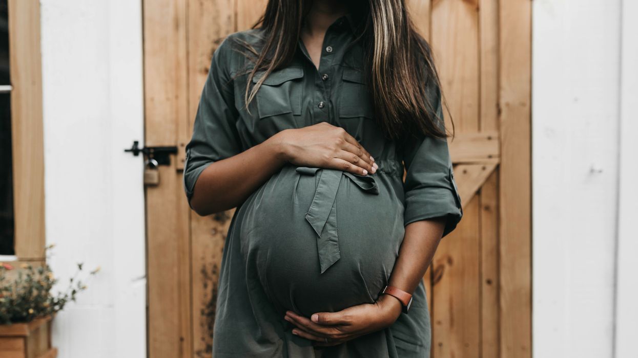 A pregnant woman in a green dress