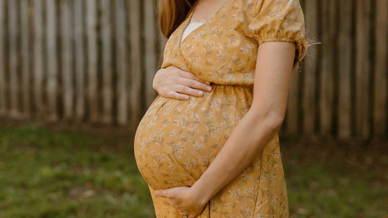 A pregnant woman outside