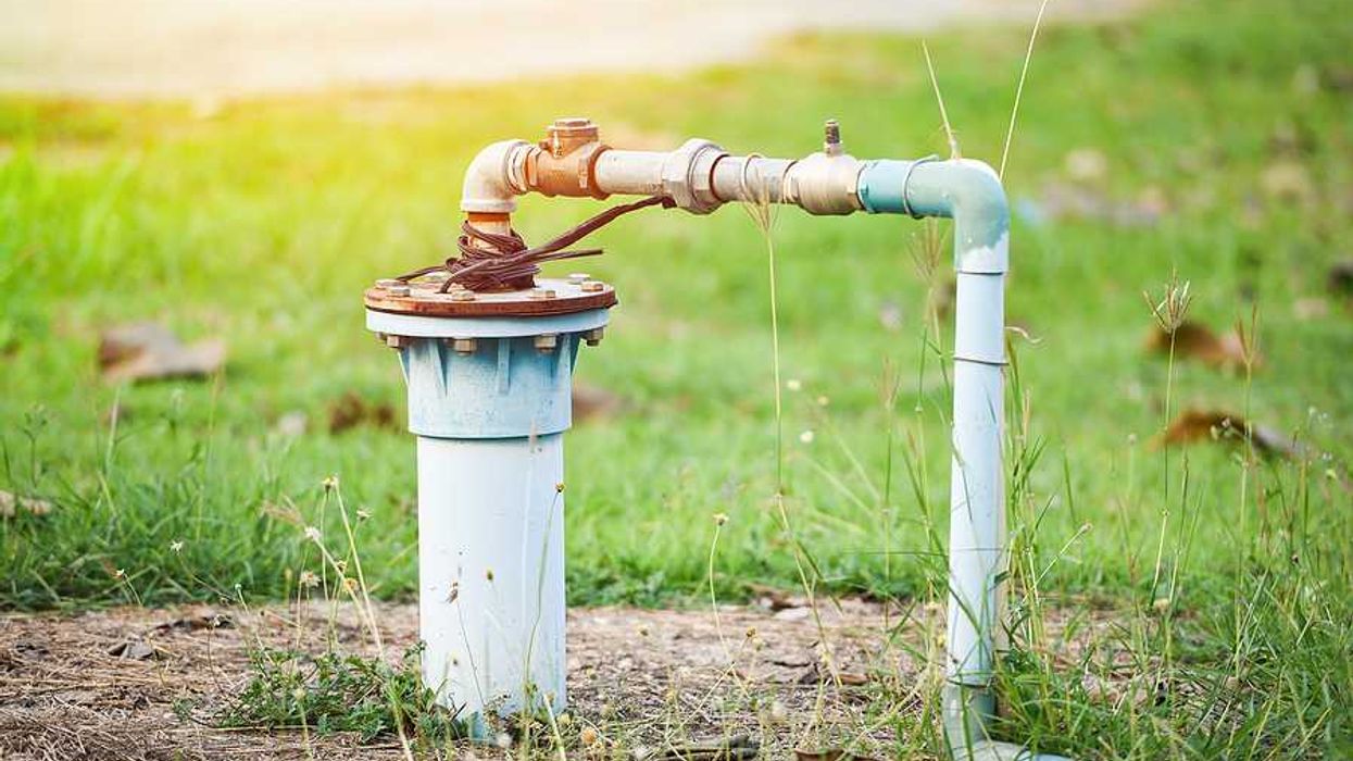 A private water well with pipes pointing into the ground