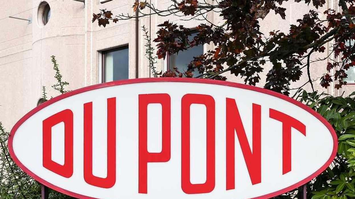 A red and white DuPont sign in front of a tan building