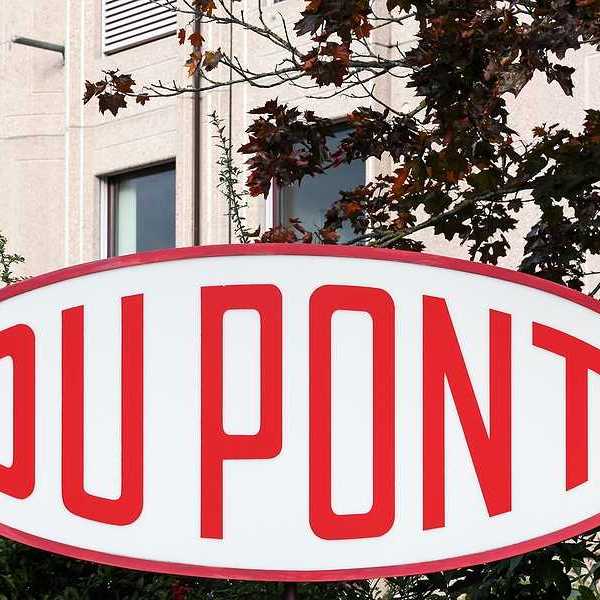A red and white DuPont sign in front of a tan building