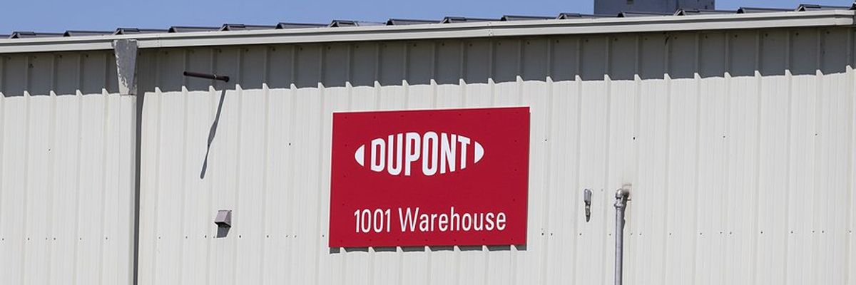 A red and white sign with the words Dupont and 1001 Warehouse on the side of a building.