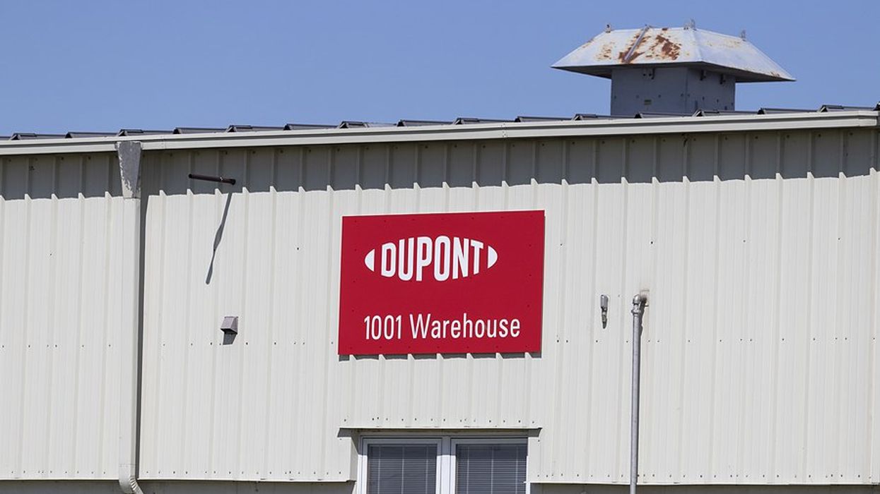 A red and white sign with the words Dupont and 1001 Warehouse on the side of a building.