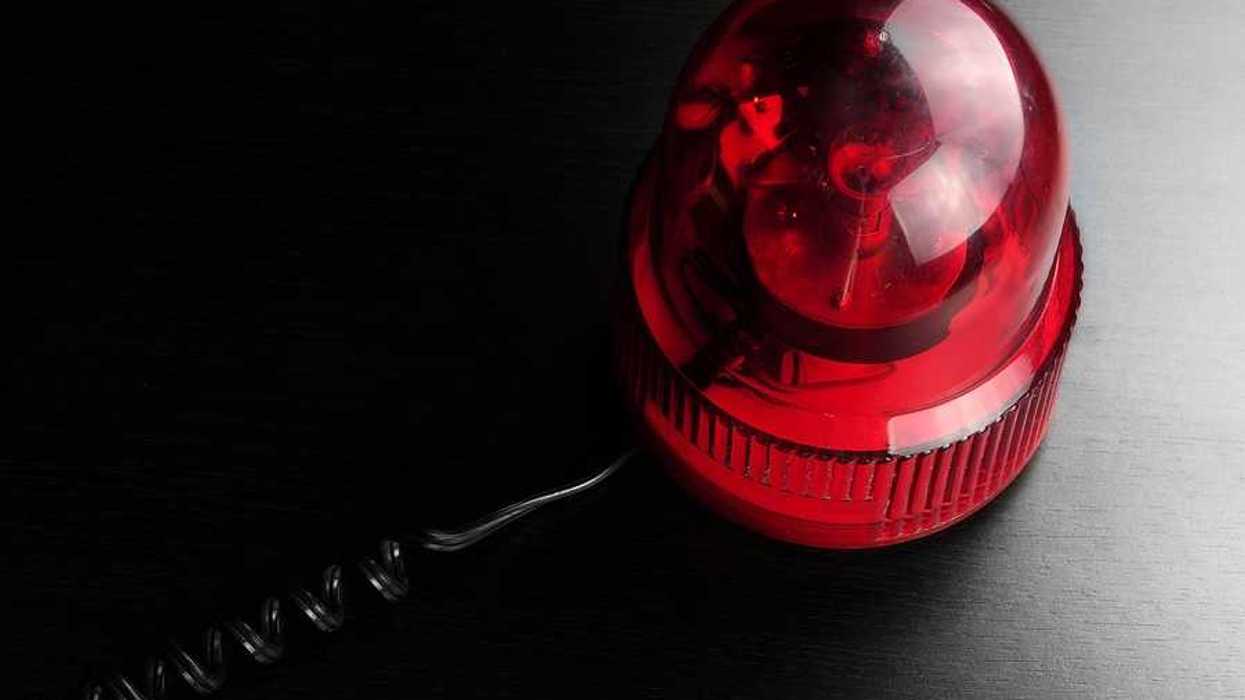 A red emergency light on a black surface