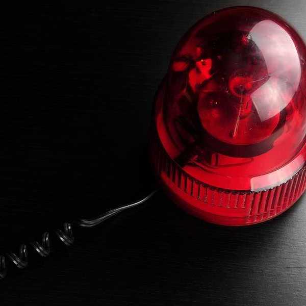 A red emergency light on a black surface