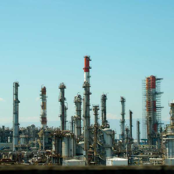 A refinery with lots of smokestacks and industrial equipment