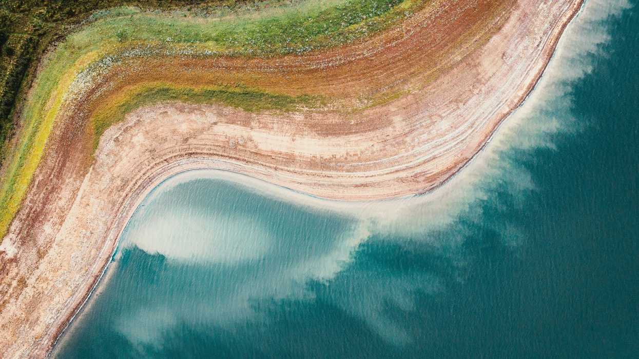 A reservoir viewed from above with dry shores