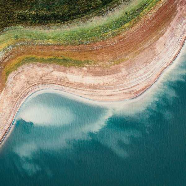 A reservoir viewed from above with dry shores