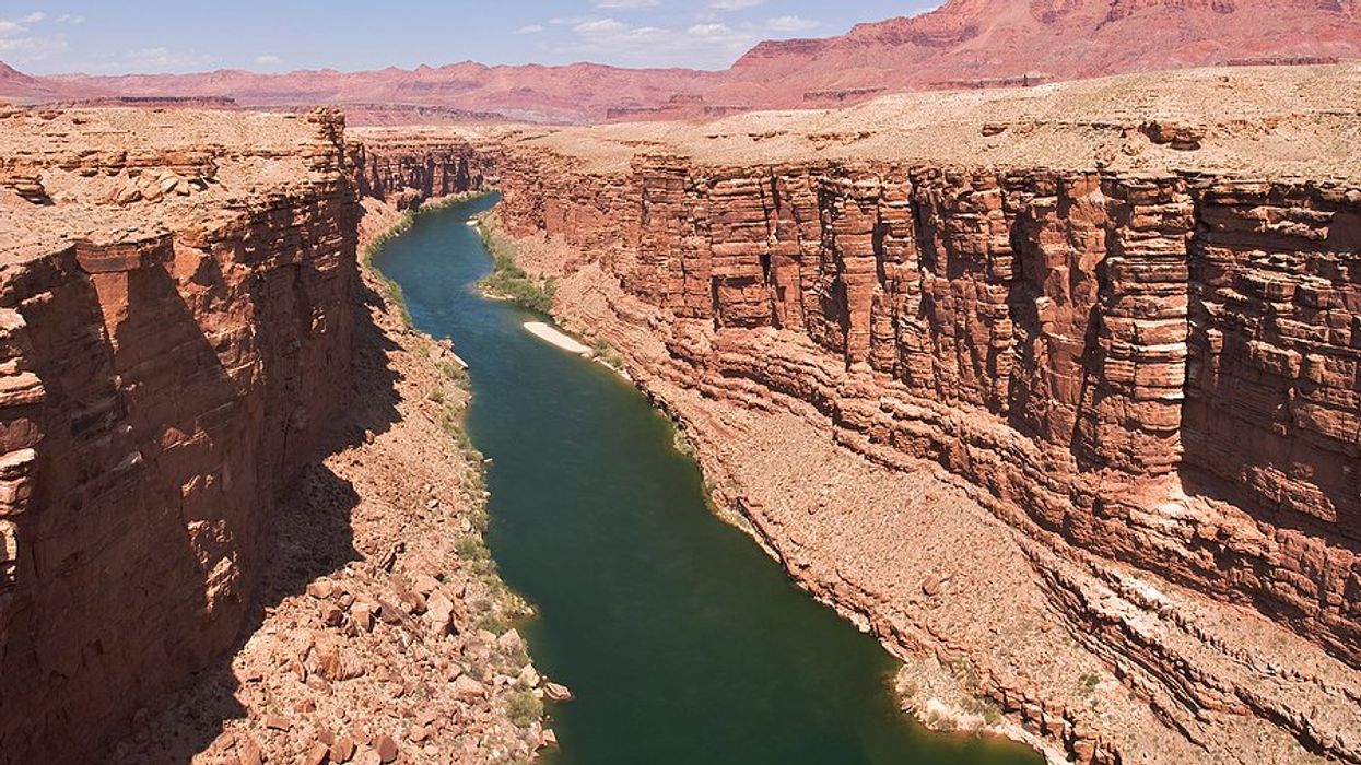 A river flowing between dry rocky bluffs