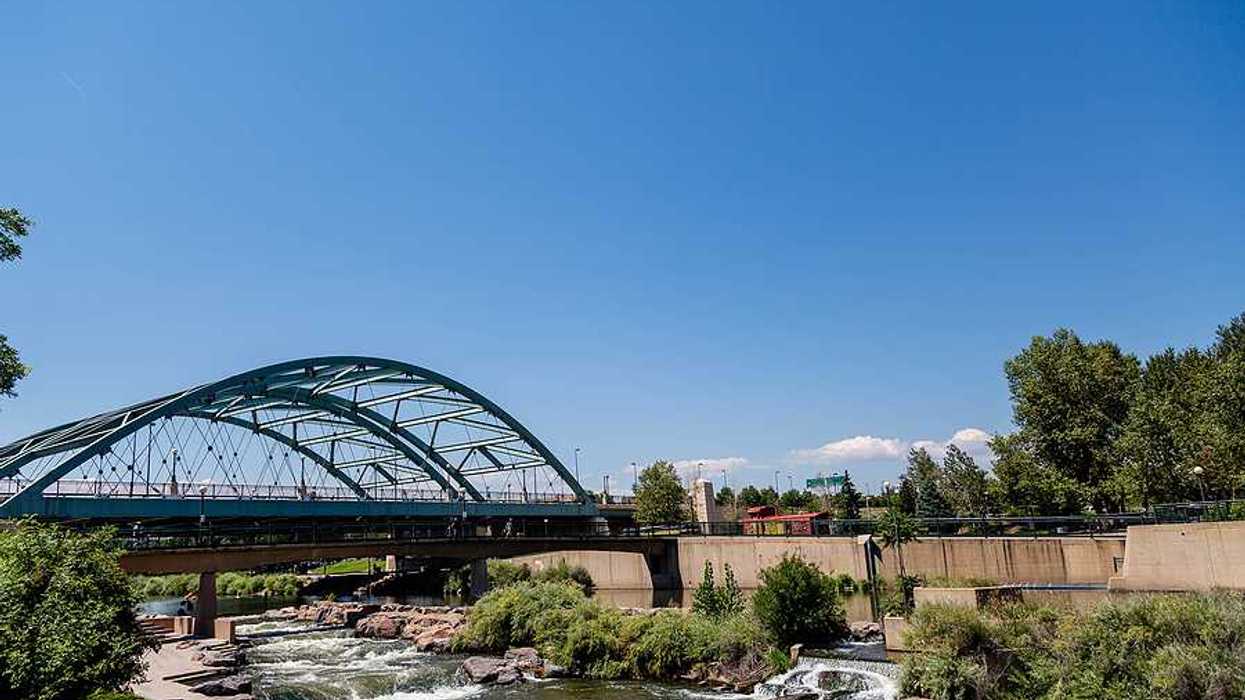 A river flowing under a steel bridge