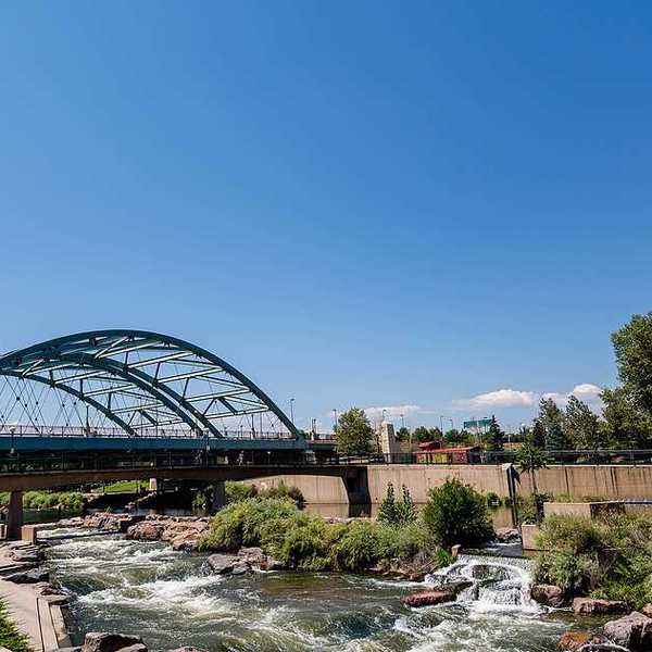 A river flowing under a steel bridge