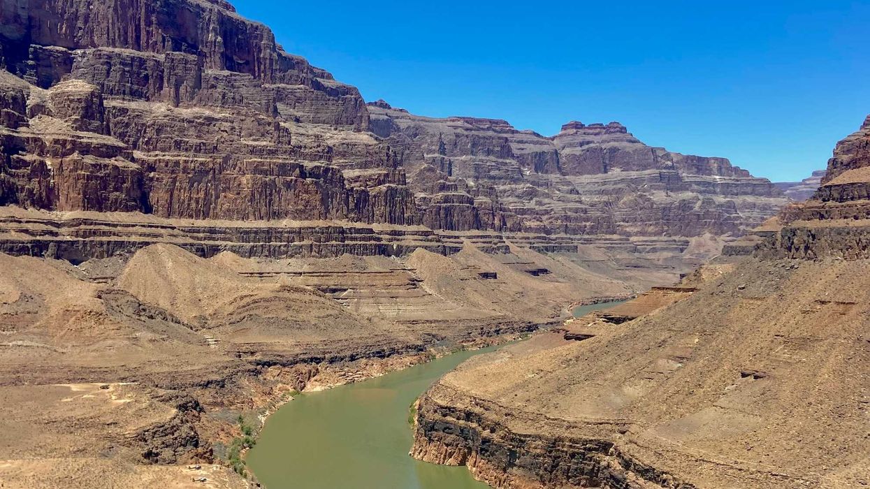 A river running through a canyon surrounded by mountains.