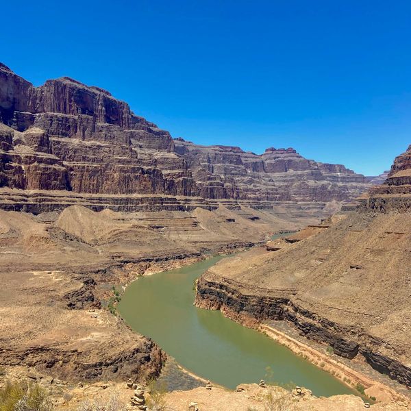A river running through a canyon surrounded by mountains.