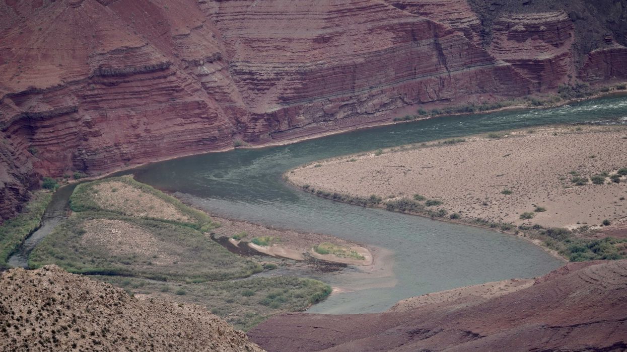 a river running through a canyon surrounded by mountains