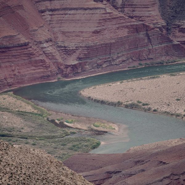 a river running through a canyon surrounded by mountains