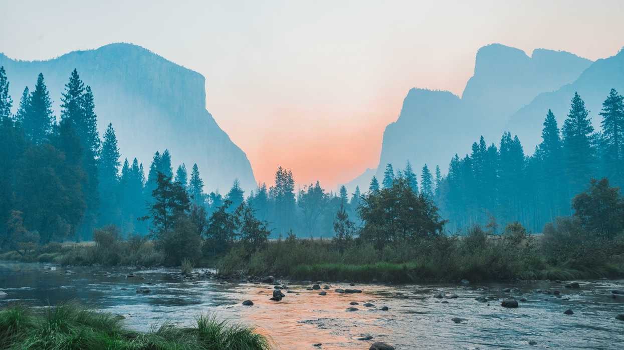 A river running through Yosemite park with half dome in the background.