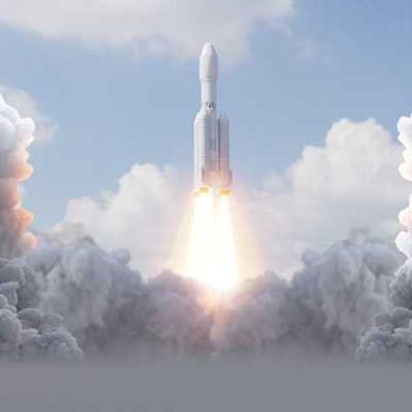 A rocket launching into the sky surrounded by smoke