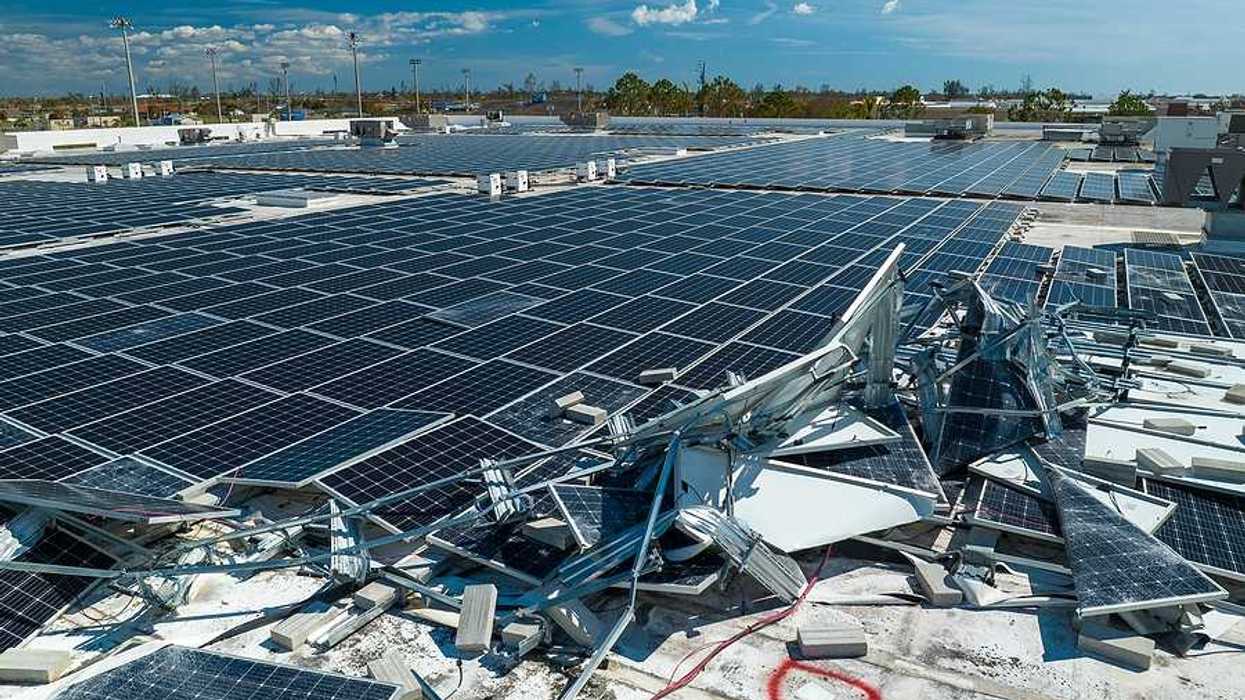 A roof with broken solar panels on it