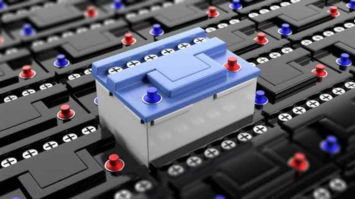 A row of black batteries with a blue battery rising in the center