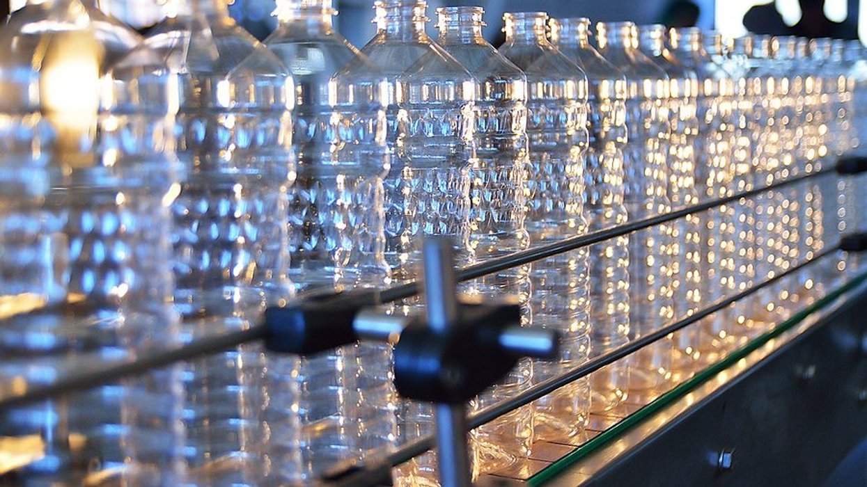 A row of plastic bottles in a production line