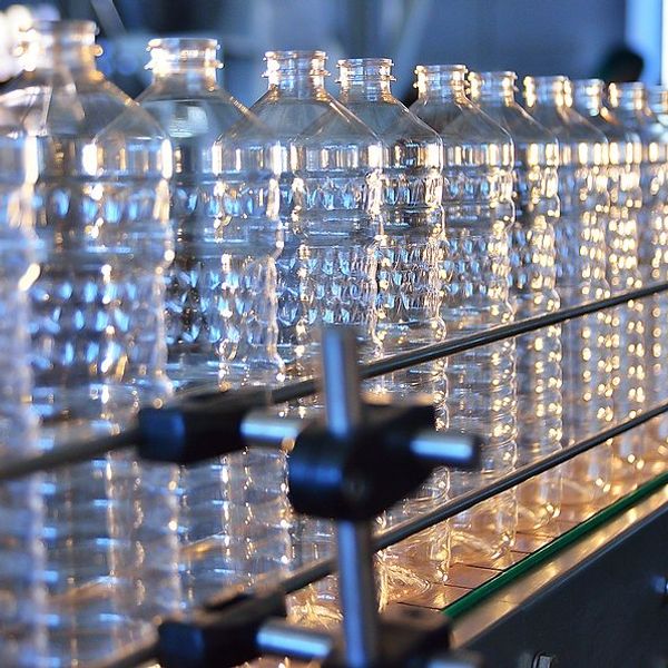 A row of plastic bottles in a production line