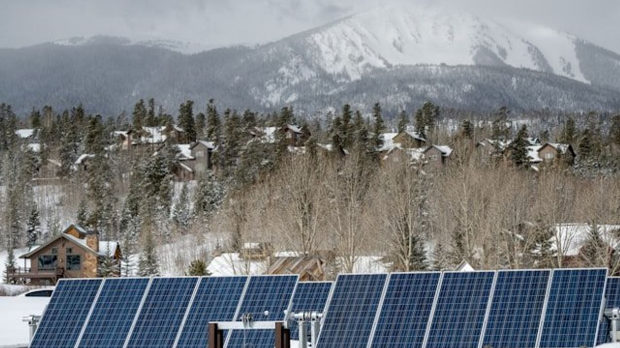A row of solar panels against a snowy background