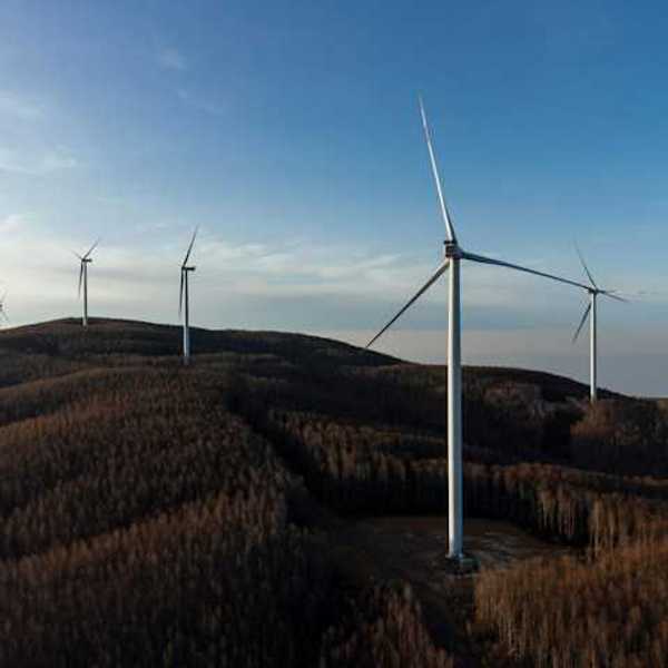 A row of wind energy turbines along the ridge of a mountain