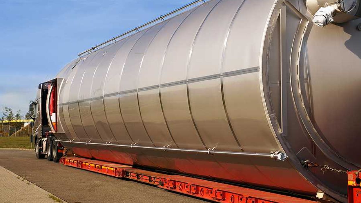 A semi truck hauling a large gas container