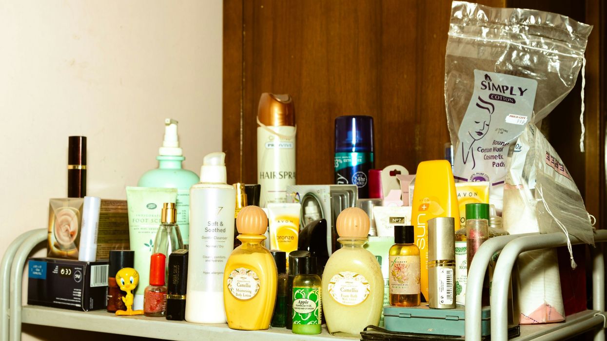 A shelf filled with lotions and personal care products in plastic bottles