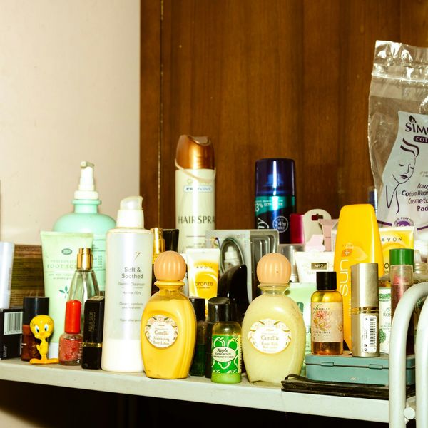 A shelf filled with lotions and personal care products in plastic bottles