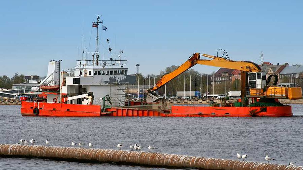 A ship is dredging a river