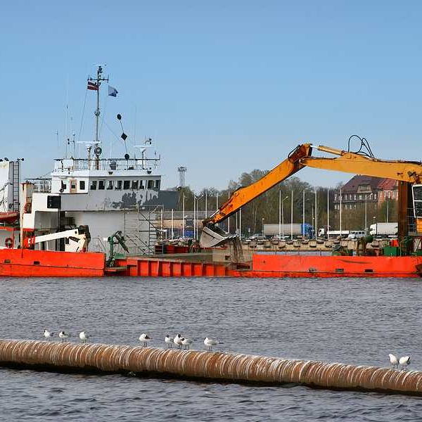 A ship is dredging a river