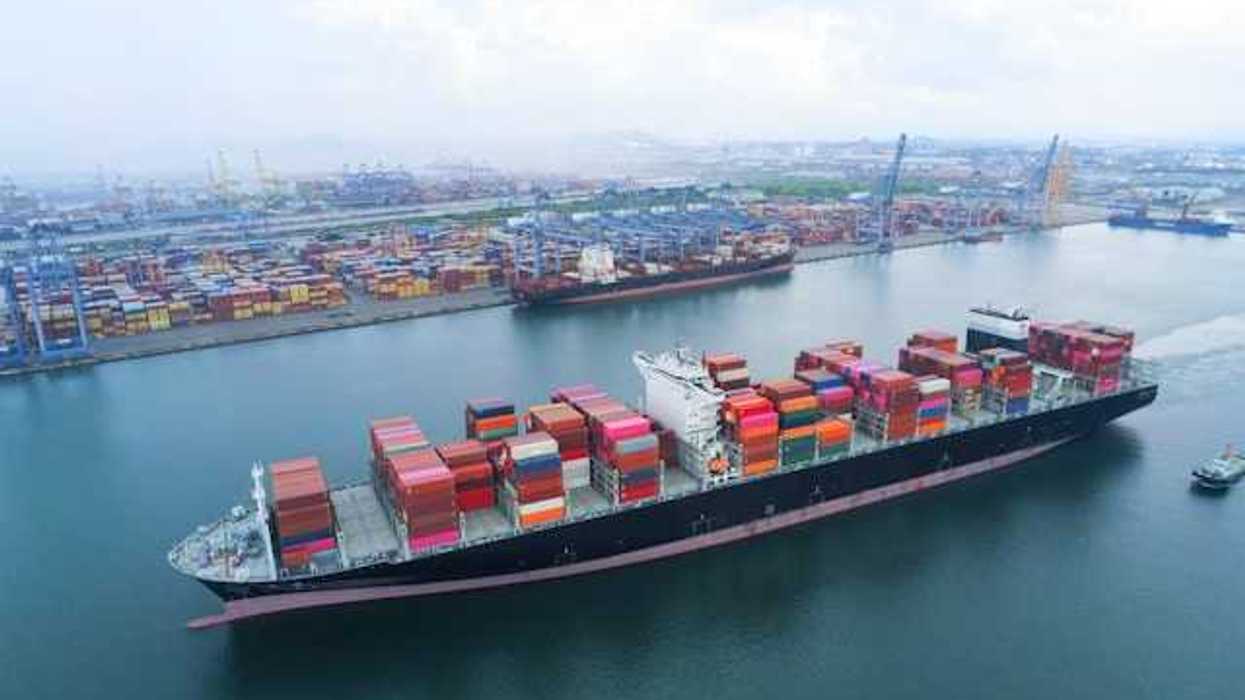 A shipping dock with a loaded tanker floating by