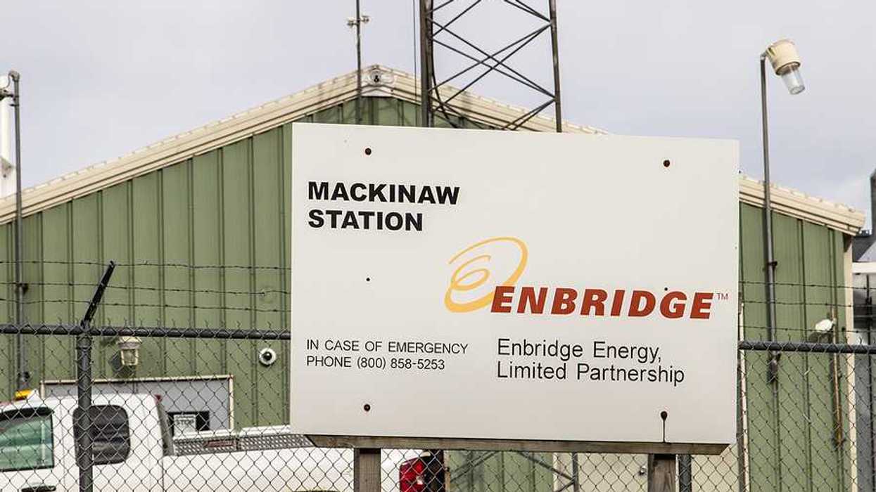 A sign that says Enbridge Energy Limited Partnership in front of a green warehouse