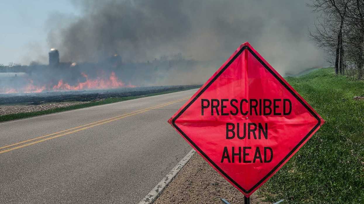 A sign warns motorists of a controlled burn area ahead on a farm in southern Wisconsin.