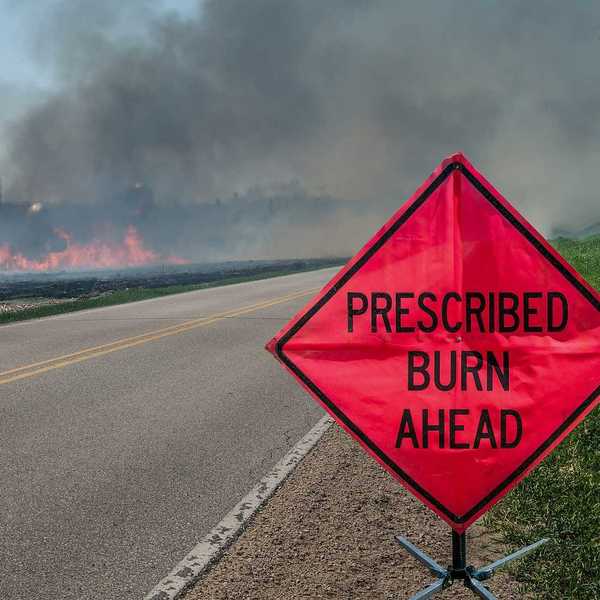 A sign warns motorists of a controlled burn area ahead on a farm in southern Wisconsin.