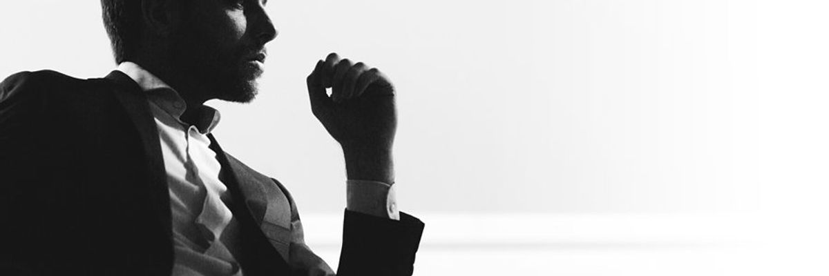 A silhouette of a businessman sitting in a chair.