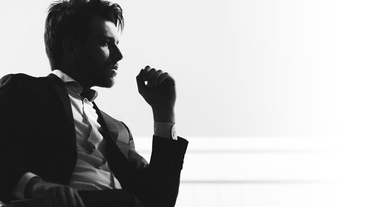 A silhouette of a businessman sitting in a chair.