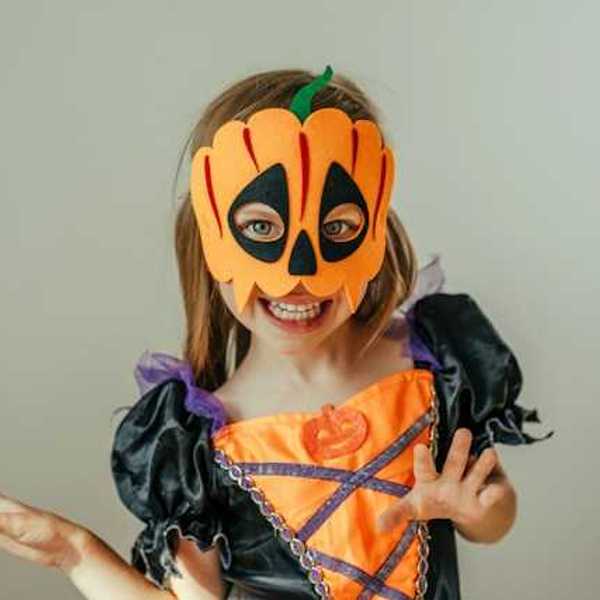 A small girl wearing a Halloween costume