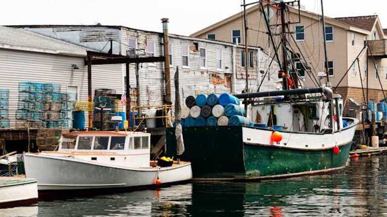 A small harbor with older fishing boats at a dock