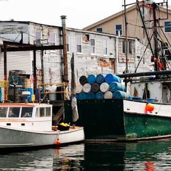 A small harbor with older fishing boats at a dock