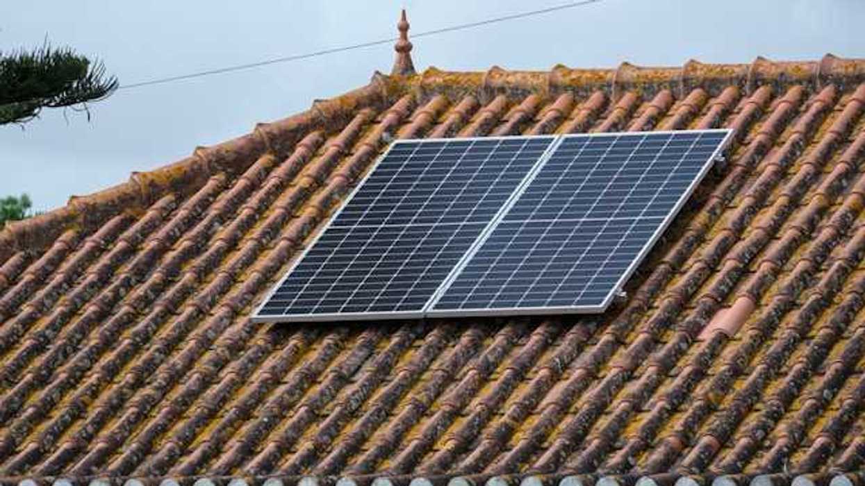 A small rooftop solar panel on a tiled roof
