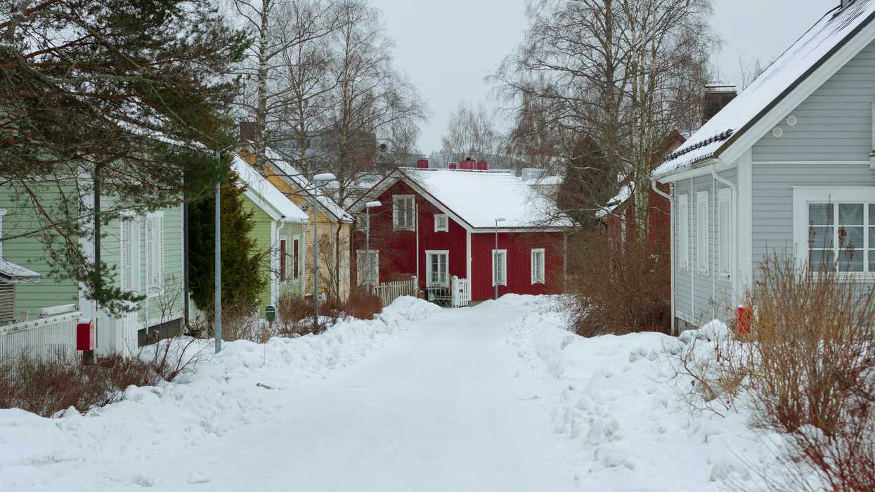 a snow covered street lined with small houses