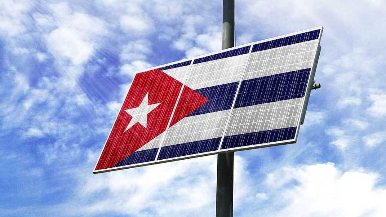 A solar panel installed on a pole imprinted with the Cuban flag