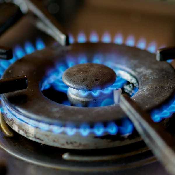 A somewhat-used lit burner on a gas stove