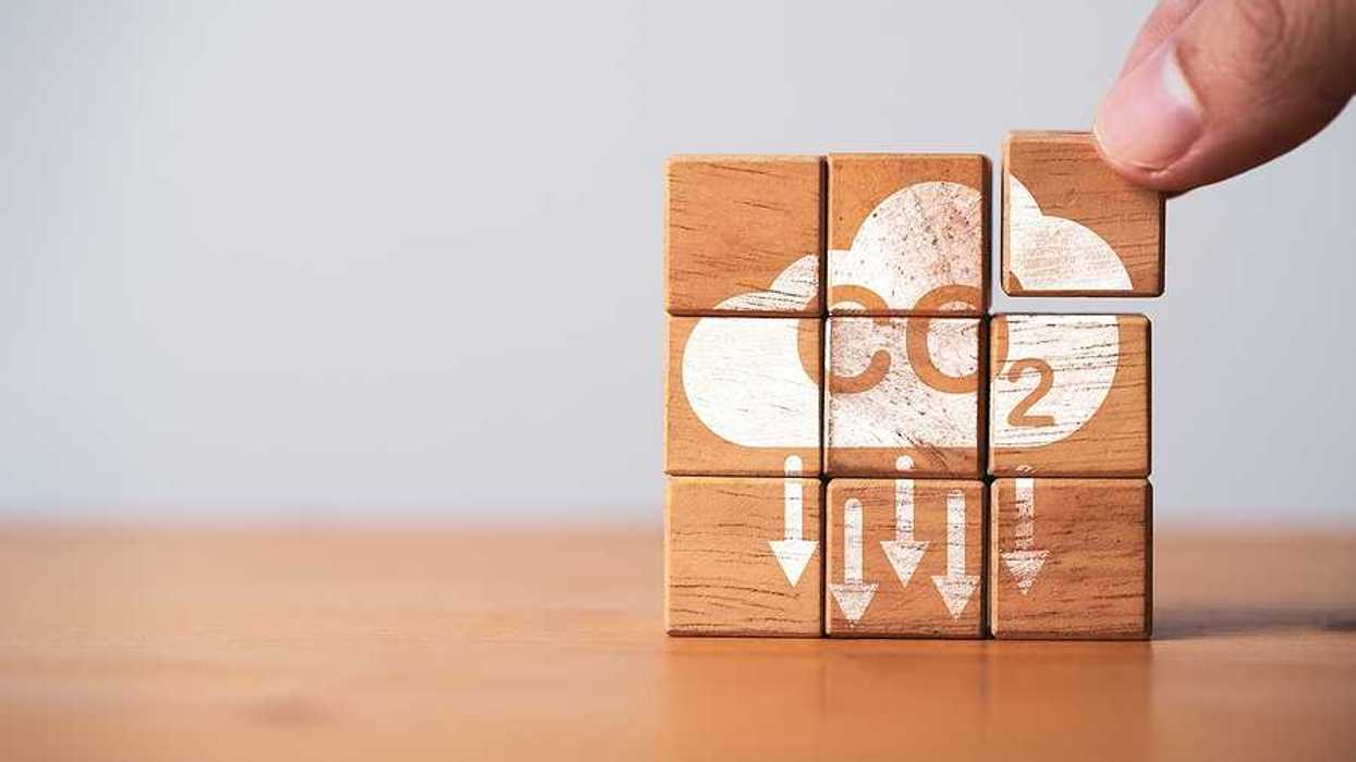 A stack of wooden blocks that say CO2 with arrows pointing downward