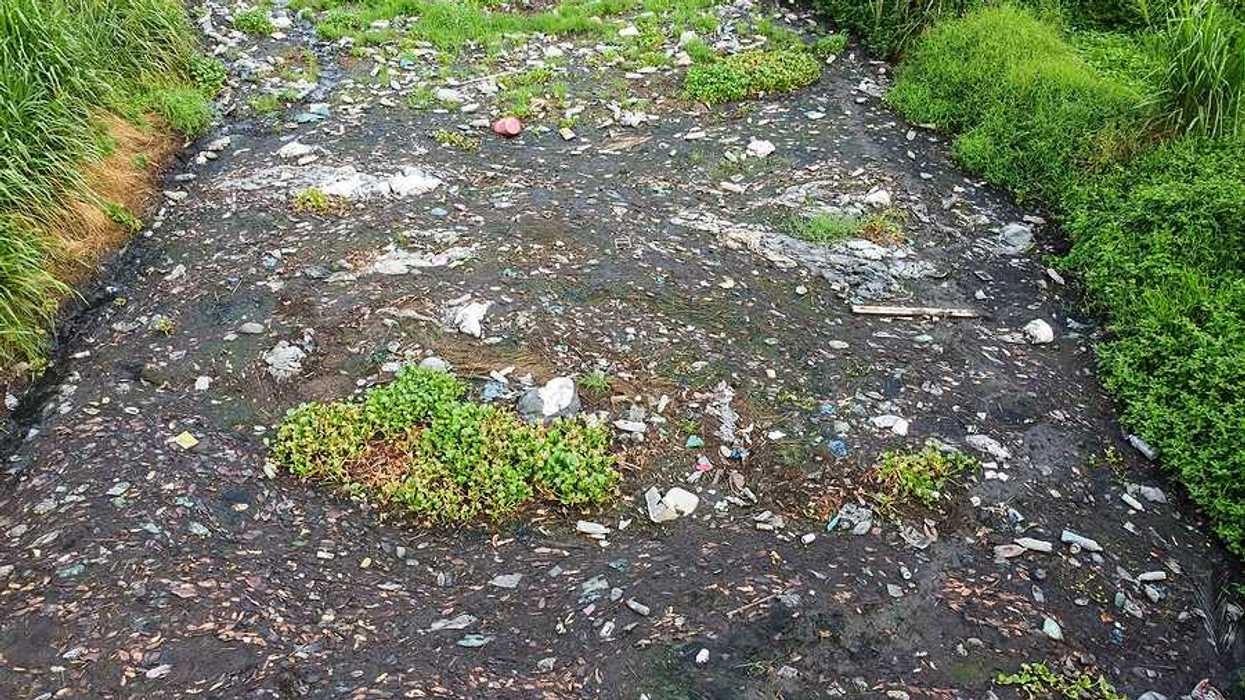 A stream filled with various types of trash