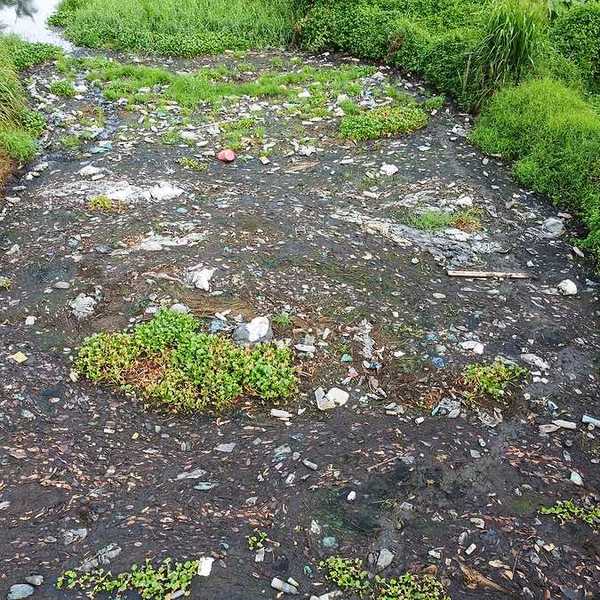 A stream filled with various types of trash