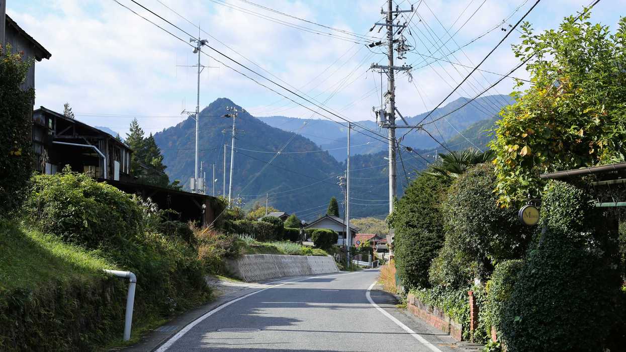 a street with a mountain in the background.